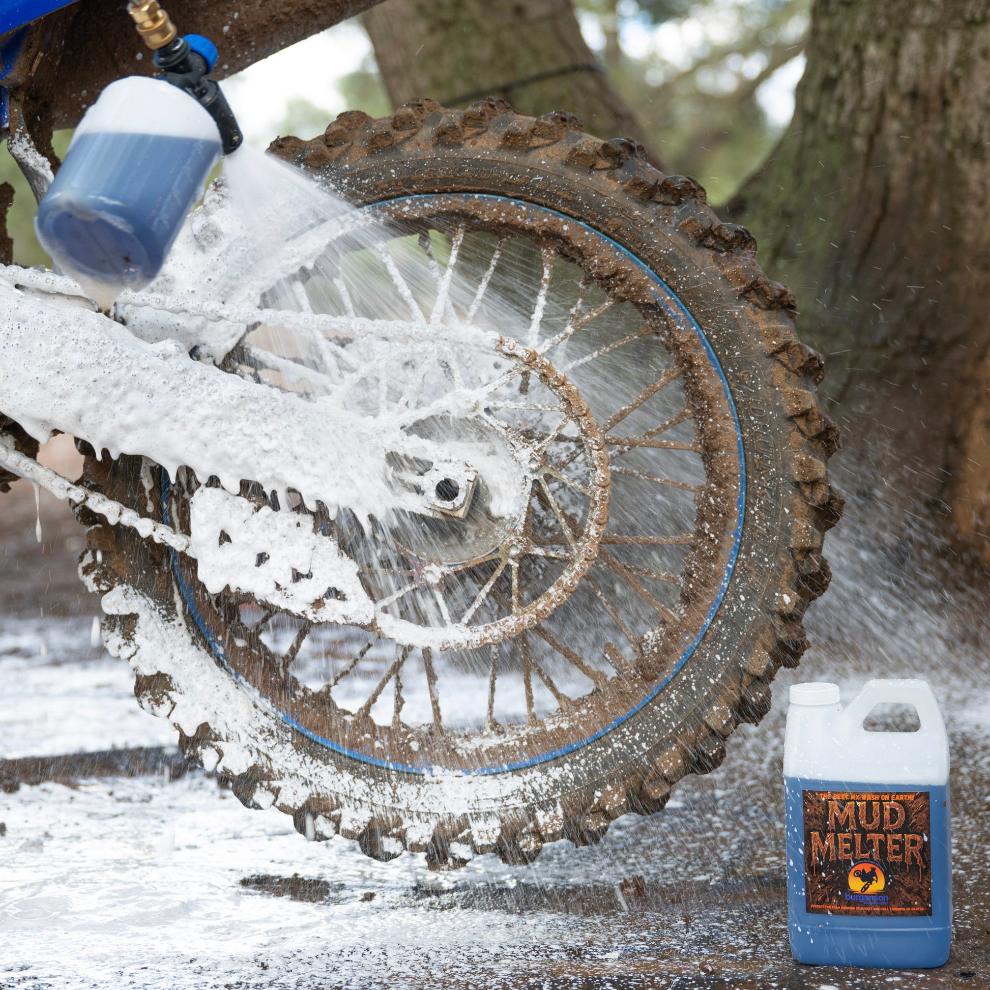 Foam cannon spraying mud remover on dirt bike