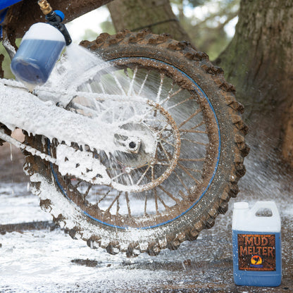 Foam cannon spraying mud remover on dirt bike